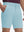 Front lower body shot of model wearing light blue flat front hybrid golf shorts