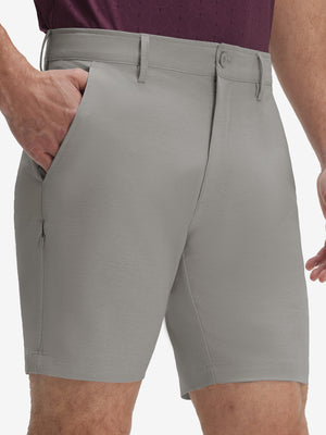Front lower body shot of model wearing light gray flat front hybrid golf shorts