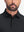 Front shot from nose to chest of model wearing black dry fit waffle textured collared golf shirts