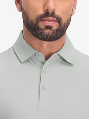 Front shot from nose to chest of model wearing silver grey dry fit waffle textured collared golf shirts