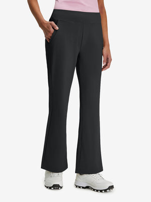 Front lower body shot of model wearing black women's high waist stretch golf pants with pockets