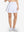 Front lower body shot of model wearing white women's high waisted golf skirts with 4 inner pockets
