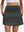 Front lower body shot of model wearing dark grey women's stretch a-line golf skort with 7 pockets