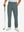 Lightweight moisture wicking dress pants in dark dusty blue, front lower-body with model leaning on golf club.