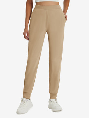 Front lower body shot of model wearing light khaki women's lightweight athletic sweatpants