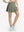 Front lower body shot of model wearing mossy stone women's high waisted golf skirts with 4 inner pockets