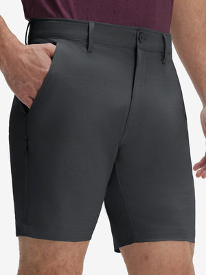 Front lower body shot of model wearing iron grey flat front hybrid golf shorts