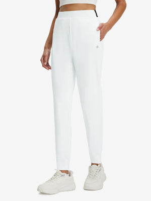 Front lower body shot of model wearing white women's lightweight athletic sweatpants