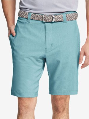 Front view of youth wearing blue light Heather Performance Golf Shorts, showing fit and style