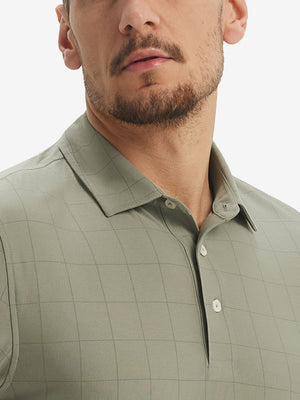 Front view from nose to chest of model wearing birch grey grid performance reflective checked collar golf shirt