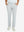 Front lower body view of model with hand in pocket, wearing quick dry casual dress pants in glacier grey.
