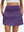 Front lower body shot of model wearing dark purple women's stretch a-line golf skort with 7 pockets