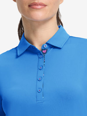 Front shot from nose to chest of model wearing sky blue women's 5 buttons collared polo shirts