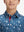 Close-up: nose to chest in space rocket performance print boys golf polo