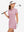 Front upper body view in pink of women's lightweight golf dress with 2 pockets.