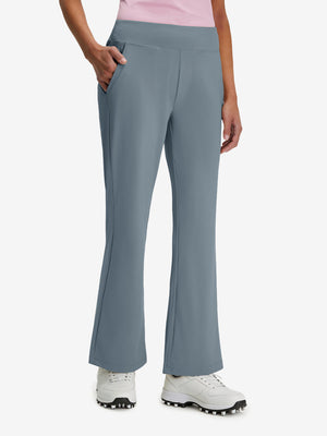 Front lower body shot of model wearing grey blue women's high waist stretch golf pants with pockets