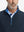 Close-up from nose to chest, showing collar detail and zipper of the navy golf vest.
