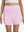 Front lower body shot of model wearing light pink women's gym golf shorts with liner pocket
