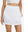 Front lower body shot of model wearing white women's stretch a-line golf skort with 7 pockets