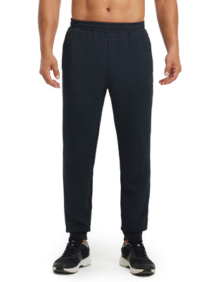 Front lower body view of model wearing soft sweatpants with 4 zipper pockets in navy