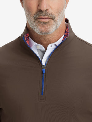 Close-up from nose to chest, showing collar and zipper detail of the coffee brown golf pullover.