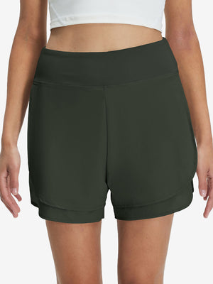 Front lower body shot of model wearing army green women's gym golf shorts with liner pocket