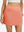 Front lower body shot of model wearing peach pink women's stretch a-line golf skort with 7 pockets