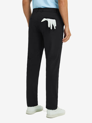 Back view of black quick dry casual dress pants, golf glove tucked in rear pocket for sporty touch.