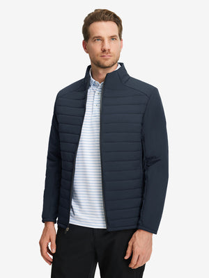 Front upper body shot of model wearing navy warm puffer winter golf jackets