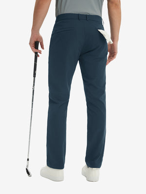 Rear lower-body: model in navy stretch quick dry casual golf pants with 4 pockets holding golf club in right hand.