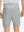 Back lower body shot of model wearing rose dust flat front flex cotton blend golf shorts