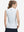 Back upper body shot of model wearing white blue florals women's sleeveless v-neck print golf shirts