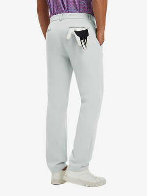 Back view of model wearing water-resistant golf stretch nylon pants, tailored stretch fit in glacier grey.