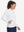 Model with one hand in side pocket wearing women's lightweight hoodies pullover in white.