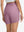 Back lower body shot of model wearing lavender pink women's high waist 2 in 1 quick dry shorts with 7 pockets
