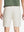 Back waist to knee view of beige water resistant golf 9 inch shorts, flexible performance fit.