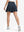 Back lower body shot of model wearing navy blue women's high waisted golf skirts with 4 inner pockets