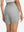 Back lower body shot of model wearing glacier grey women's high waist 2 in 1 quick dry shorts with 7 pockets