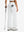 Back lower body shot of model wearing white women's high waist stretch golf pants with pockets