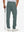 Back lower-body view of lightweight moisture wicking dress pants, model with golf club in dark dusty blue.