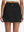 Back lower body shot of model wearing black high waist built-in short a-line golf skirt with 5 pockets