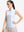 Front upper body shot of model wearing white blue florals women's sleeveless q-zip print quick dry golf tops