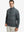 Front upper body view of model standing in retro black/red plaid full print quarter zip pullover, relaxed look.