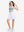 Front full body shot of model wearing white women's high waisted golf skirts with 4 inner pockets