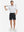 Front full body shot of model wearing black flat front flex cotton blend golf shorts