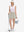 Front full body shot of model with golf gear wearing oyster gray women's stretch a-line golf skort with 7 pockets