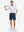 Front full body shot of model wearing dark blue flat front flex cotton blend golf shorts