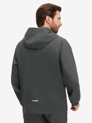 Back upper body shot of model wearing dark grey waterproof lightweight rain jacket with hood