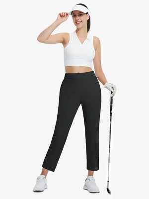 Full-body front view wearing golf hat and holding club in BLACK Women's 7/8 Ankle Golf Track Pants.