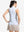 Back upper body shot of model wearing white blue florals women's sleeveless q-zip print quick dry golf tops